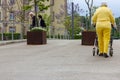 senior lady in yellow dress with rollator