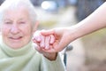 Senior Lady and Young Woman Holding Hands Royalty Free Stock Photo