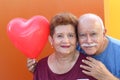 Senior Latino Couple holding a heart balloon Royalty Free Stock Photo