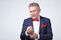 Senior lawyer wearing blue suit while standing against white background