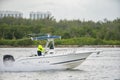 Senior lifestyle concept. Old man pilot sport fishing boat. Shot with 300mm telephoto lens