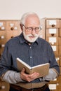 senior male archivist reading Royalty Free Stock Photo