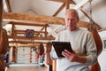 Senior Male Boxing Coach In Gym Tracking Training Using Digital Tablet Royalty Free Stock Photo