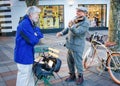 Senior male chats with street musician