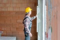 Senior male construction worker measuring the wall Royalty Free Stock Photo