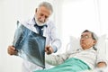 Doctor and patient are examining x-ray film. Royalty Free Stock Photo