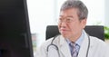 Senior male doctor look computer Royalty Free Stock Photo