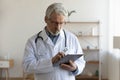 Senior male doctor use modern tablet at workplace Royalty Free Stock Photo