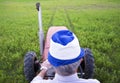 Senior male farmer sitting on a tractor