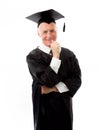 Senior male graduate standing with finger in mouth Royalty Free Stock Photo