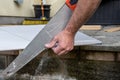 Senior male hands cutting plaster board for home improvements.