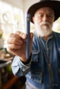 Aged man with insuline pen inside flower shop Royalty Free Stock Photo