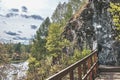 Senior male hiker admiring landscape with river on wooden hiking trail near cliff. Nature park Royalty Free Stock Photo