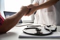 Senior male patient handshaking with Doctor female. Royalty Free Stock Photo