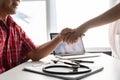 Senior male patient handshaking with Doctor female. Royalty Free Stock Photo