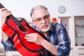 Senior male repairman repairing musical instruments at home Royalty Free Stock Photo