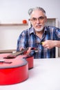 Senior male repairman repairing musical instruments at home Royalty Free Stock Photo