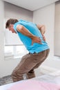 Senior male suffering sharp back pain, sick person getting up from bed, after rest Royalty Free Stock Photo