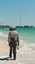 Senior, male surf fisherman walking