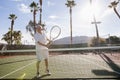Senior male tennis player holding racket on court Royalty Free Stock Photo