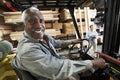 Senior Male Worker Driving Forktruck Royalty Free Stock Photo