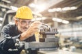 senior male worker engineer working high skill and precision with CNC lathe machine metal steel factory. healthy elderly worker Royalty Free Stock Photo