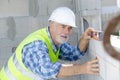 senior male worker measuring wall Royalty Free Stock Photo