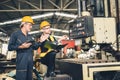 senior male worker training new young engineer employee working in heavy industry metal factory Royalty Free Stock Photo