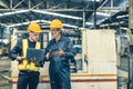 senior male worker training new young engineer employee working in heavy industry metal factory Royalty Free Stock Photo