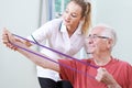 Senior Male Working With Physiotherapist