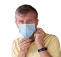 Senior man adjusting face mask and looking very worried about the epidemic Royalty Free Stock Photo