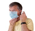 Senior man adjusting face mask and looking very worried about the epidemic Royalty Free Stock Photo