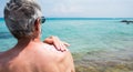 Senior man applying sun lotion on summer vacation Royalty Free Stock Photo