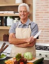 Senior man and arms with knife in kitchen or confident, tomato and carrots for diet. Male chef and portrait with healthy Royalty Free Stock Photo