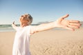 Senior man with arms outstretched standing at beach Royalty Free Stock Photo