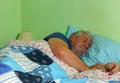 Senior man asleep in bed.