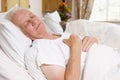 Senior Man Asleep In Hospital Bed Royalty Free Stock Photo