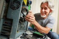 Senior Man Assembling A Desktop Computer