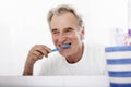 Senior Man In Bathroom Brushing Teeth Royalty Free Stock Photo