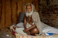 Senior man with beard sitting on the bed