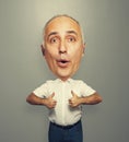 Senior man with big head showing thumbs up Royalty Free Stock Photo