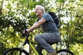 Senior man biking in the park Royalty Free Stock Photo