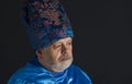 Senior man in blue oriental clothes Royalty Free Stock Photo
