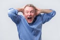 Senior man with angry grimace on his face,with mouth opened in shout Royalty Free Stock Photo