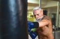 Senior man boxer training hard - Elderly male boxing in sport gym center club Royalty Free Stock Photo