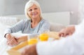 Senior man bringing his wife breakfast in bed Royalty Free Stock Photo