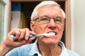 Senior man brushing his teeth Royalty Free Stock Photo