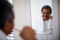 Senior man brushing teeth in bathroom Royalty Free Stock Photo