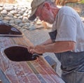 Senior man building wood strip kayak