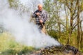 Senior man is burning dry branches in the garden Royalty Free Stock Photo